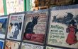 A close up of posters displayed on a street stall