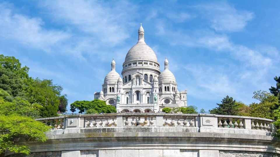 View of the Sacre-Coeur from the bottom of the balcony on a sunny cloudy day