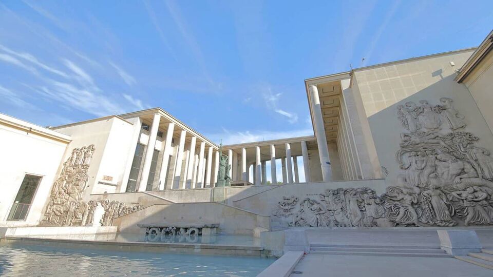 Front view of Museum of Modern Art building and the art carved onto the walls on a sunny blue day