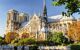 Landscape view of the entire Notre Dame building on a sunny blue skied day