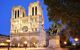 A side view of the cathedral at night with street lights and lights on the cathedral itself, illuminating the dark