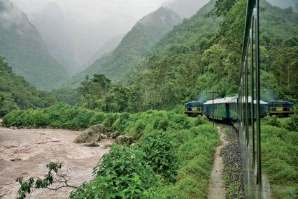 A train winding through green mountains