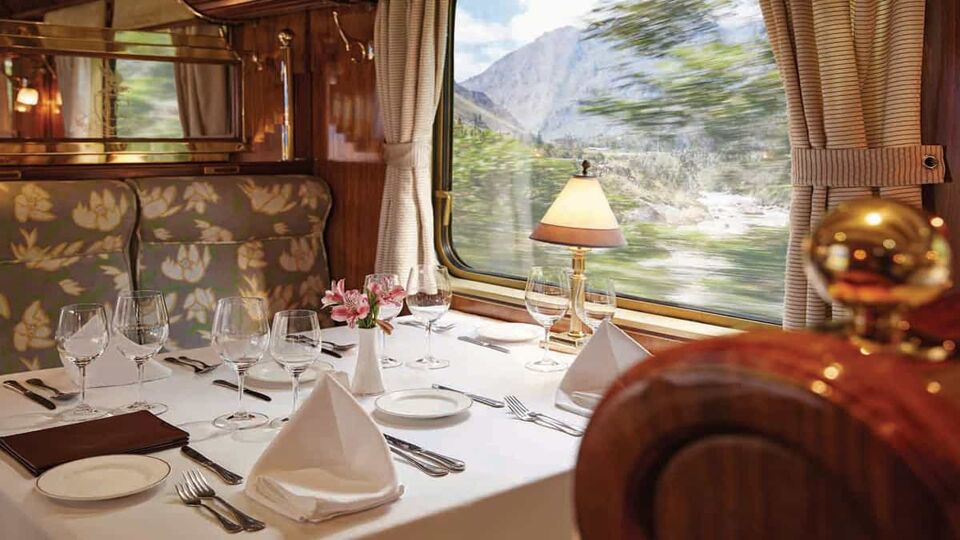The inside of a train carriage, set for dinner