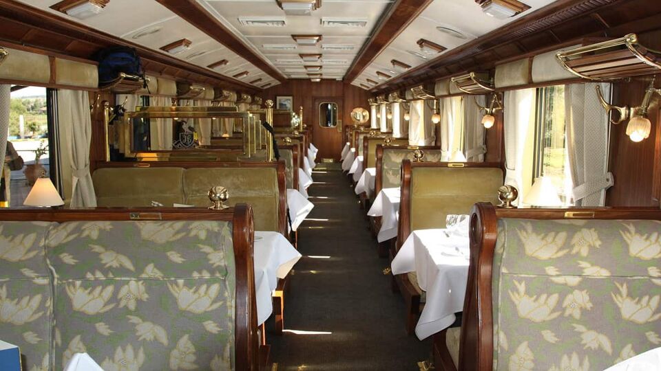 A train carriage with tables set for dinner