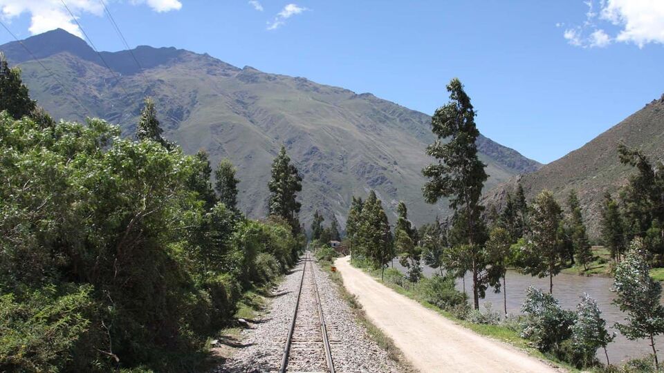 A train track leading towards a mountain
