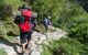 Two hikers descending a stony path