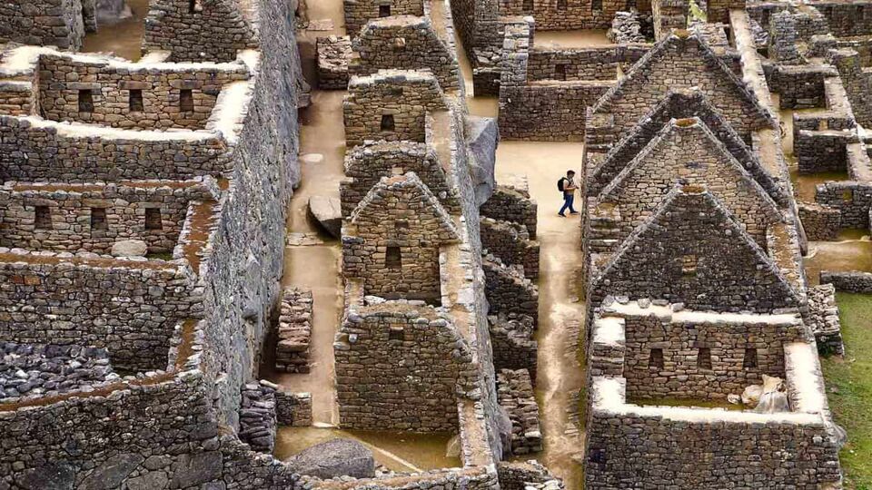 A tourist walks alone through the ruins