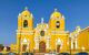 Central square of Trujillo, with large canary yellow church