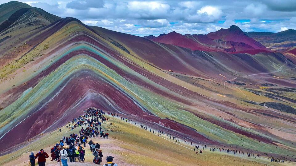 People summiting Rainbow Mountain