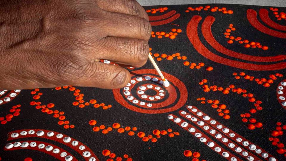 Aboriginal art, white and red dots to form shapes.