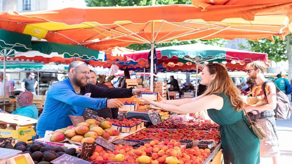 Woman buying fruit from a fruit seller