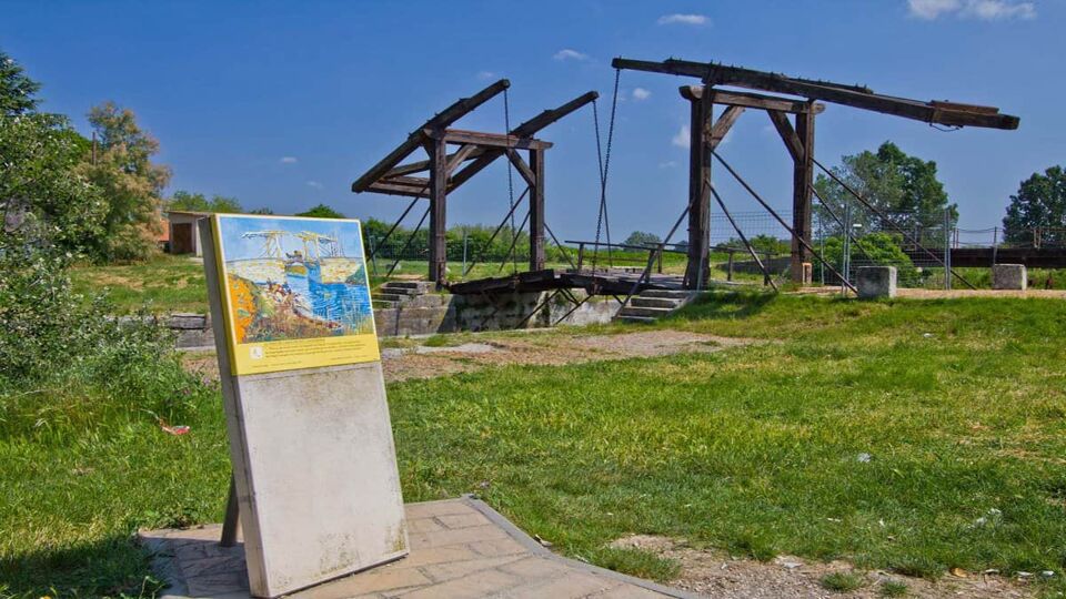 The Langlois Bridge beside a replica of a Van Gogh painting