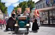Performers in historical dress advertise their theatre performance