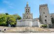 Avignon cathedral (Cathedral of Our Lady of Doms) next to Papal palace (Palais des Papes under clear blue sky in Avignon, France