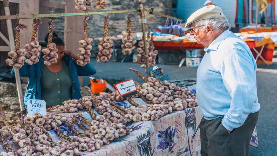 man at amrket stall in gordes