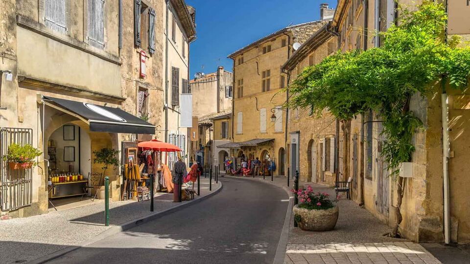 A sunlit street in the hill top village of Lourmarin