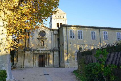 The exterior facade and entrance of the St Paul de Mausole, a golden stone building