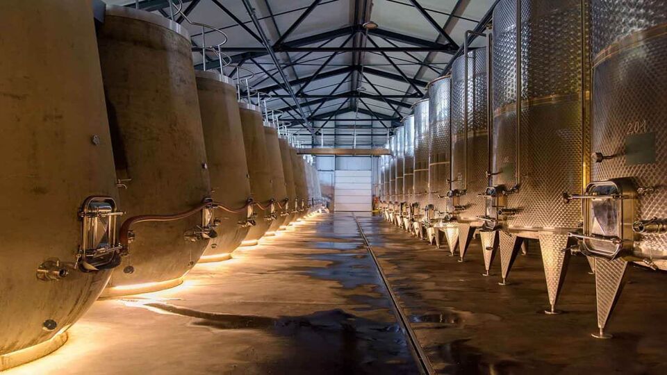 View down a row of large wine vats