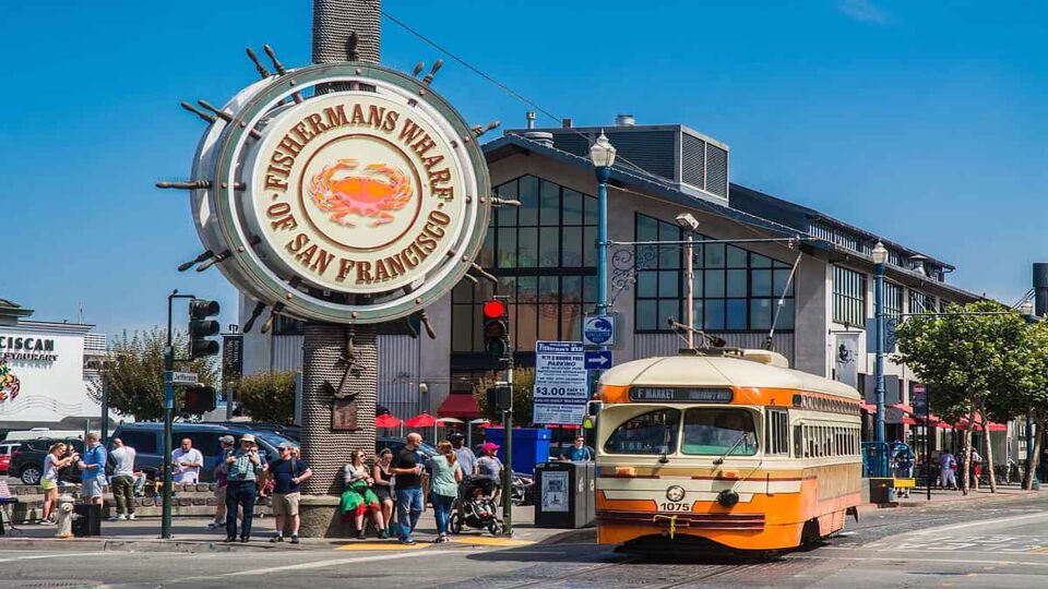fisherman's wharf sign with bus out front