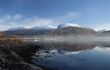 view of a lake with snow-capped Ben Nevis mountain behind