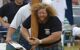 Close up of a participant in Tartan kilt holding a caber at the Highland Games