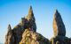 Tourists climbing Old Man of Storr rock formation at Isle of Skye, Scotland