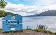 Blue sign of Loch Ness, with the Loch behind