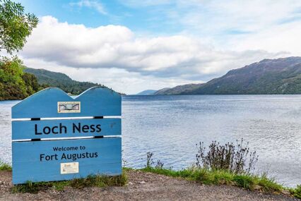 Blue sign of Loch Ness, with the Loch behind