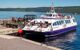 a small ferry boat picking up passengers for a tour of Loch Nesss