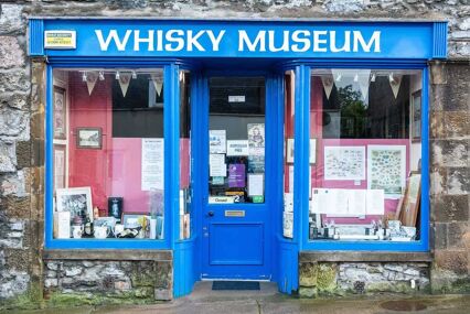 Whisky Museum in Dufftown. The museum houses a selection of distillery memorabilia. Exterior view with doors and windows.