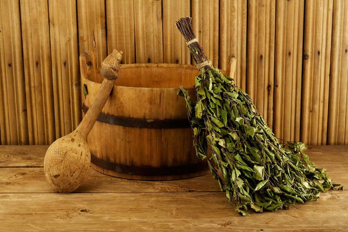 Eucalyptus branches and a bucket in a sauna