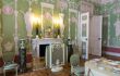 Pale green room with high ceilings and ornate panelling
