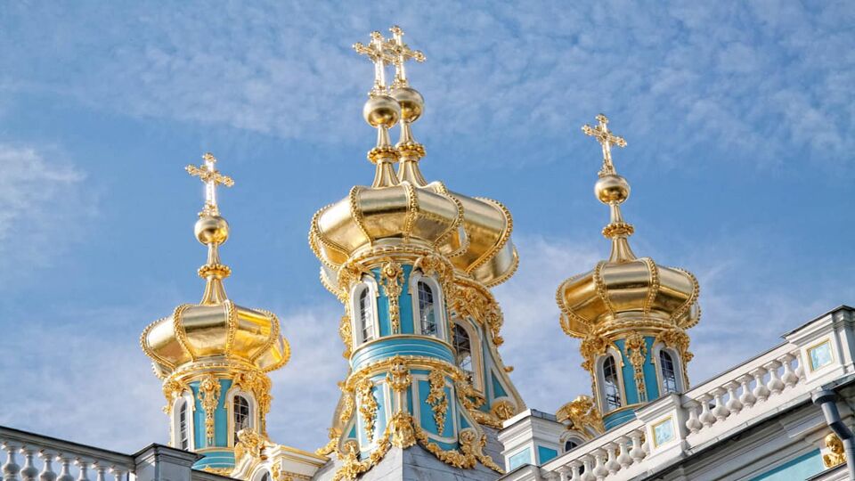 Gold turrets of palace under blue sky