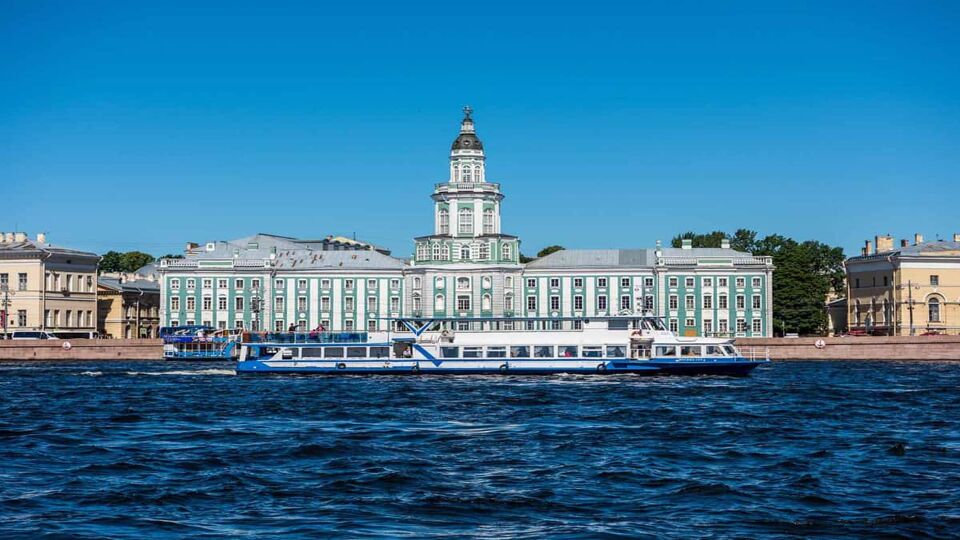Canal boat passes large domed palace
