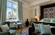 French windows in double bedroom with sofa and armchair