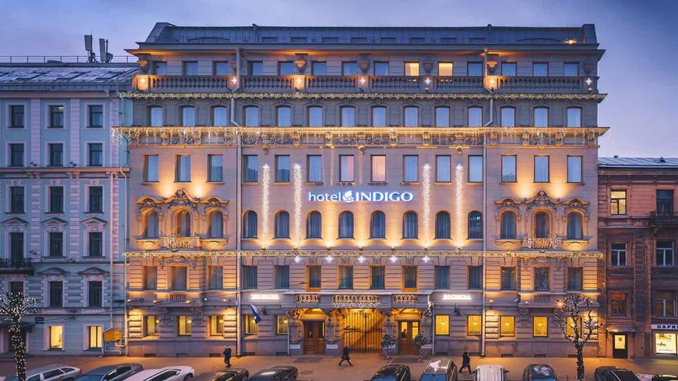 City hotel frontage with dozens of windows lit at night