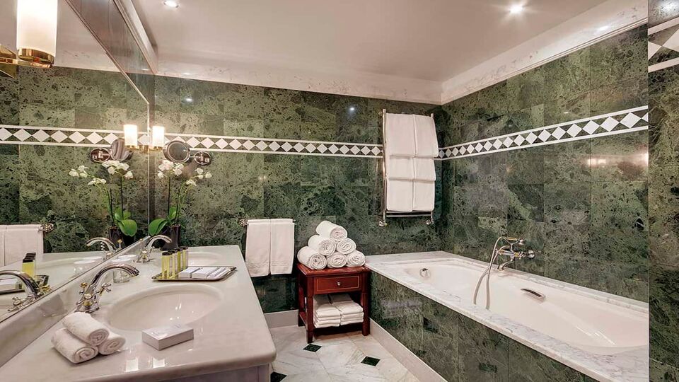 Green tiled ensuite with bathtub