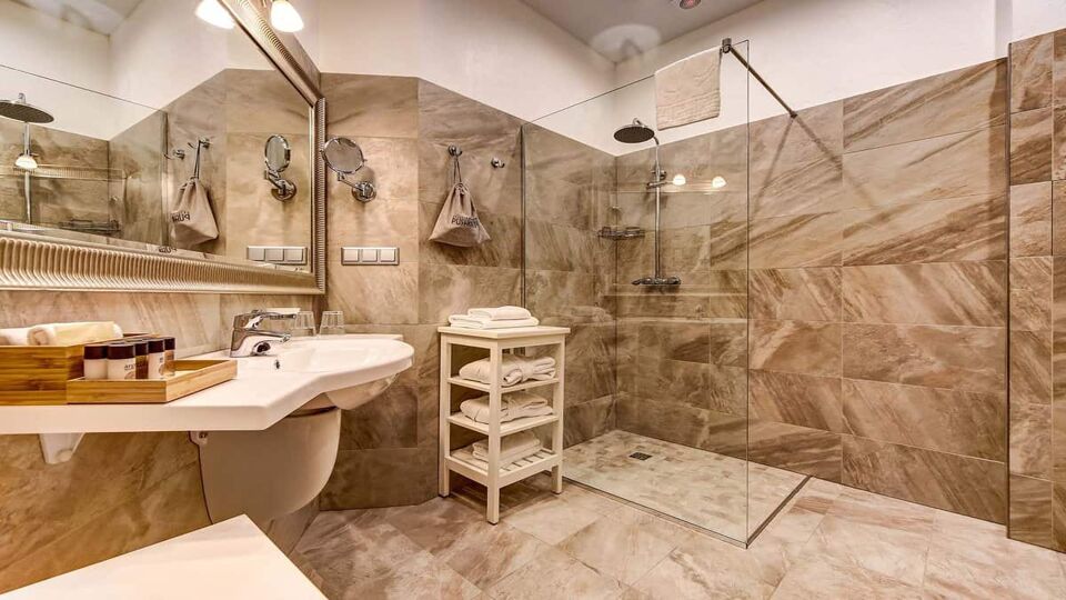 Marble tiled bathroom with shower and