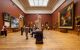 Gallery room with skylight and large oil paintings
