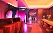 Hotel bar lit in purple and pink