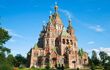 Exterior of an elaborate red stone cathedral