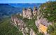 A jagged, rocky mountain covered in greenery.