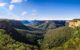 Silhouettes of green mountains on a sunny day.