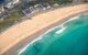 A photo of a golden beach from above on a sunny day.