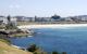 A photo of the beach from across the water.