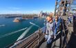 man at the top of the bridge looking out over Circular Quay