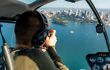 Man in helicopter looking out over Sydney Harbour
