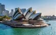 Sydney opera house from across the harbour on a sunny day.