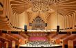 an extravagant, modern, wooden interior of a concert hall