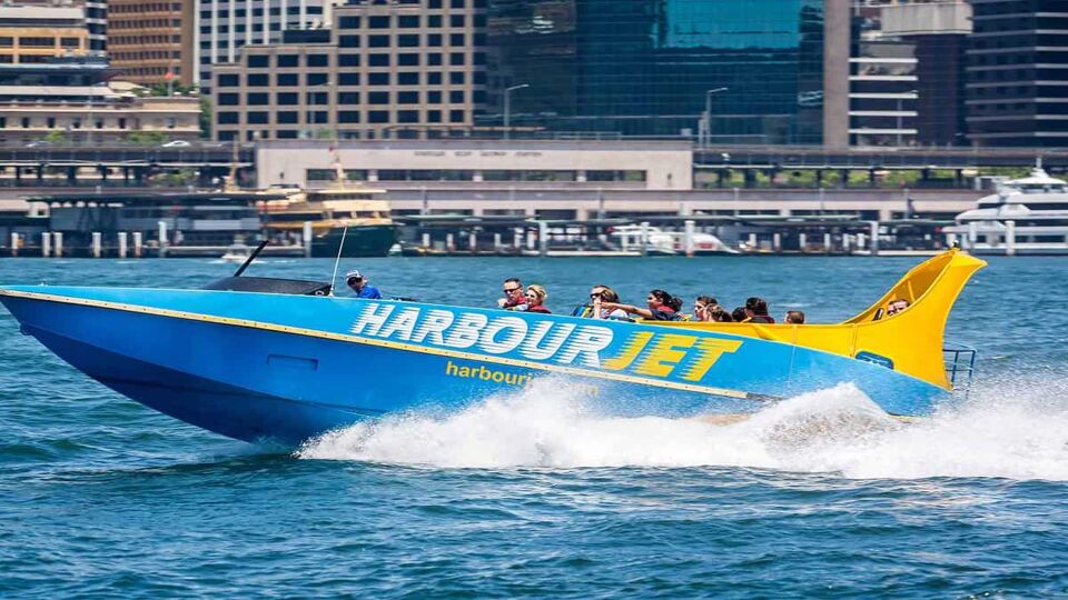 A speed boat driving fast through Sydney harbour.